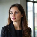 Portrait of a young professional woman, looking engaged and thoughtful, representing 'Jessica R'.